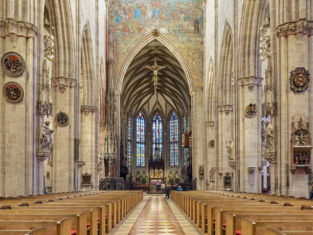 Interior of the Ulm Minster, Germany Ulm, Germany - December 16, 2017: Interior of the Ulm Minster, Germany. The church was laid in 1377, consecrated in 1405 and completed in 1890. Last Judgment fresco above the choir arch was painted in 1471 by Hans Schuchlin. ulm minster stock pictures, royalty-free photos & images