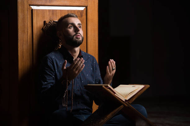 istock Muslim Man Reading Holy Islamic Book Koran 1196403479