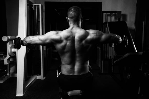 istock Man With Dumbbells Exercising Shoulders 1196403542