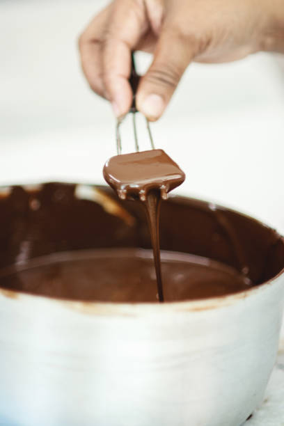 istock Chocolate being produced manually in a factory 1196409476