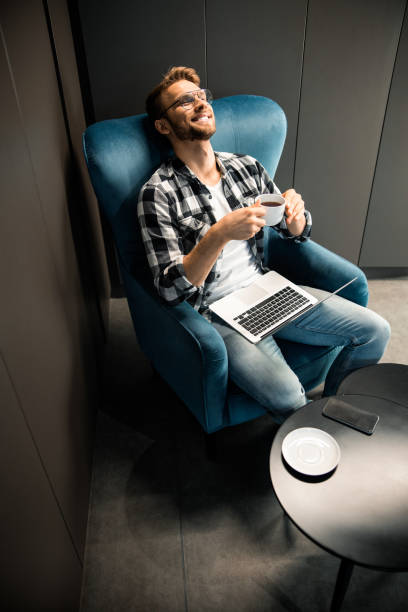 istock Happy young man resting with cup of coffee 1196410104