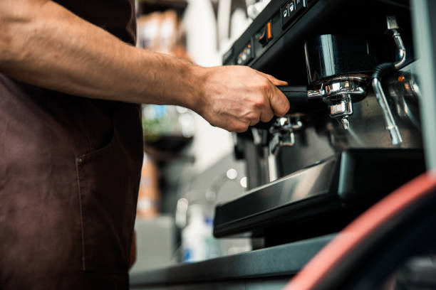 istock Barista preparing espresso in his coffee shop 1196410137