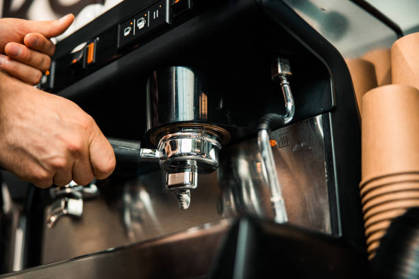 istock Barista hand holding filter and pressing coffee to making an espresso 1196410139