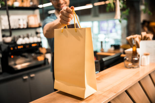 istock Smiling barista is working in coffee house 1196410144