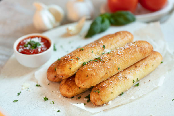 Garlic Breadsticks Garlic breadsticks on with marinara sauce marinara stock pictures, royalty-free photos & images