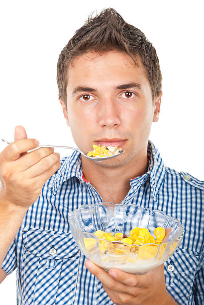 istock Young man eating cornflakes cereals 119641526