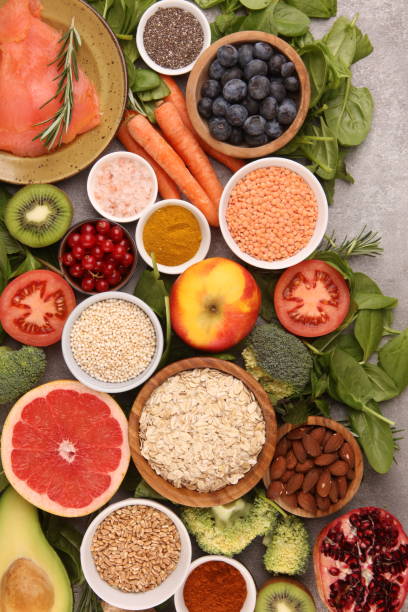 istock Healthy food clean eating selection: fish, fruit, vegetable, cereal, leaf vegetable on rustic background 1196416717