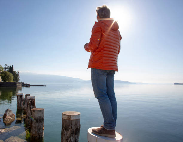 istock pier lake sun one person 1196420438