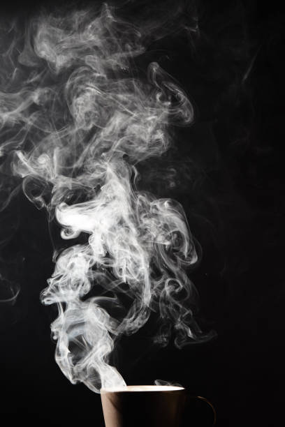 istock Steaming coffee cup on dark background, White smoke on dark 1196423264