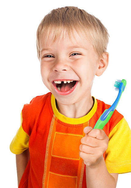 istock left-handed smiley boy with toothbrush 119642550