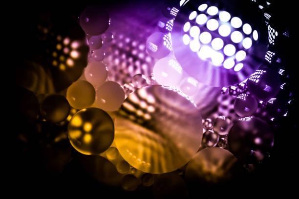 istock Creative abstraction background from colorful circles of different sizes with backlight and gradient in yellow, pink and violet color. 1196426052