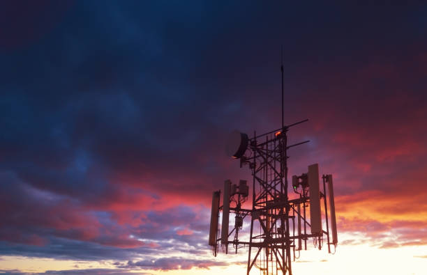 Cellular Tower Aerial drone view of a cellular tower in evening light. telecommunications equipment stock pictures, royalty-free photos & images