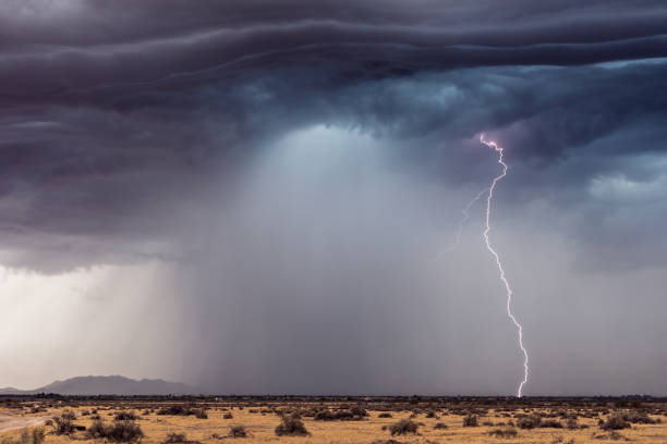 Thunderstorm lightning strike Thunderstorm lightning strike with dark storm clouds and heavy rain. Microburst stock pictures, royalty-free photos & images