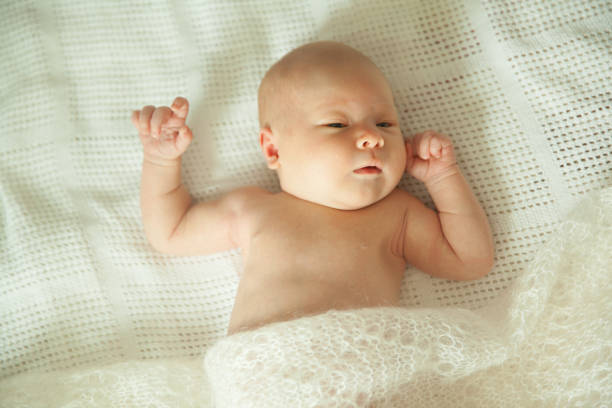 istock cute newborn baby sleeping covered with fluffy blanket. 1196430583