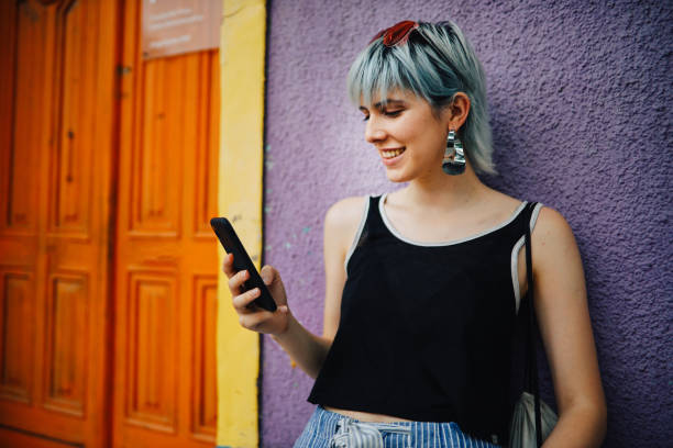 istock Girl using phone outdoors 1196431473