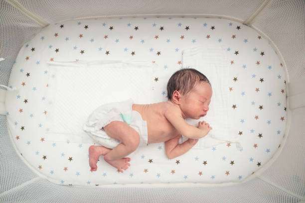 istock Sleeping newborn baby in a crib 1196436513