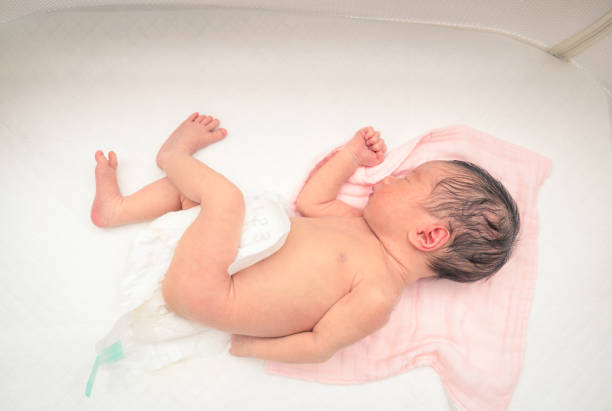 istock Sleeping newborn baby in a white crib 1196437035
