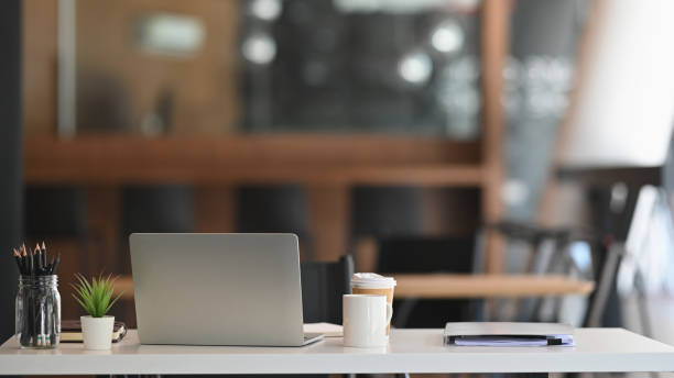 istock Front view laptop on white table is document paper, pencil holder In modern office workplace. 1196442284