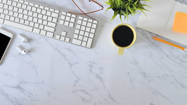 istock Top view marble table office with computer, coffee, office supplies and mobile phone. 1196442364