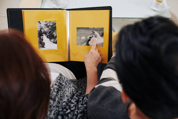 istock Mother showing son wedding photos 1196443107