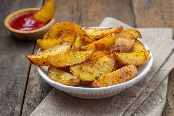 istock Baked potato with spices, herbs and ketchup. 1196445504