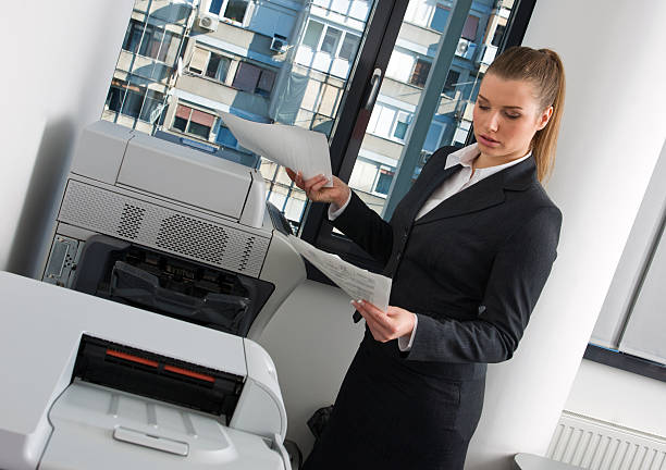 istock business woman next to office printer 119644949