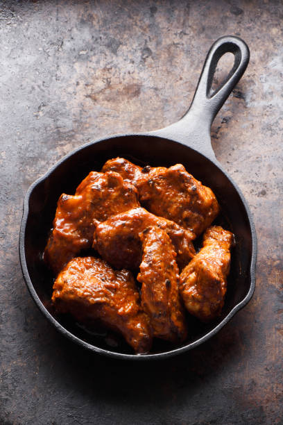 istock Chiken wings in a skillet 1196452324