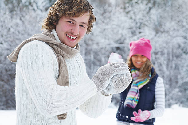 istock Couple playing snowballs 119645416