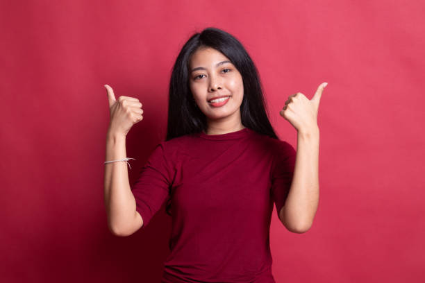 istock Young Asian woman show two thumbs up. 1196455821