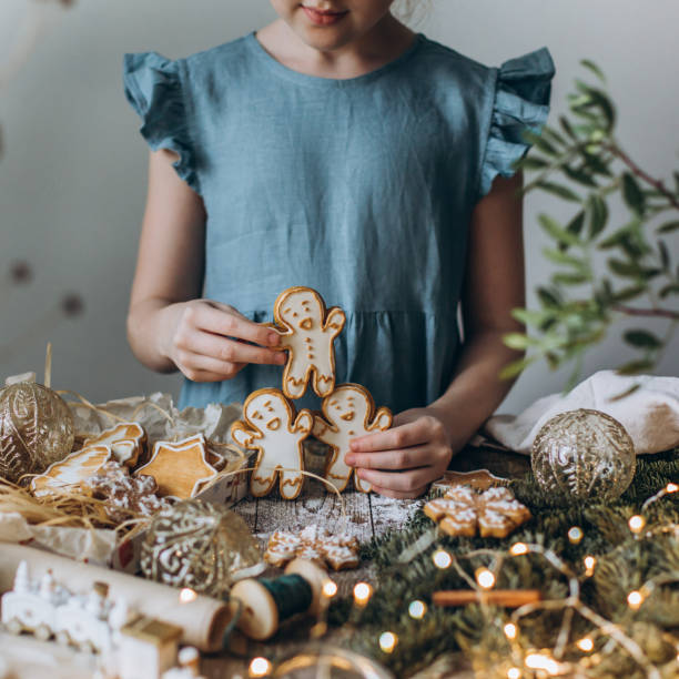 istock Children's hands play gingerbread man over the table 1196459441