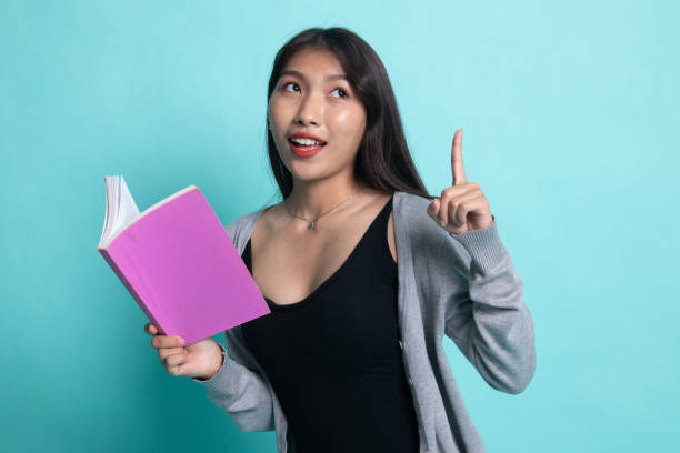 istock Young Asian woman with a book have an idea. 1196465627