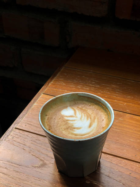 istock Coffee with froth art on wooden table 1196471769