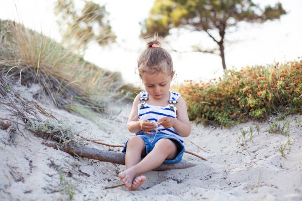 istock girl playing with at the beach 1196472622