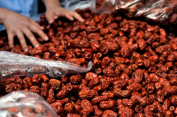 Jujube, Chinese dried red date fruit for sale on market stock photo