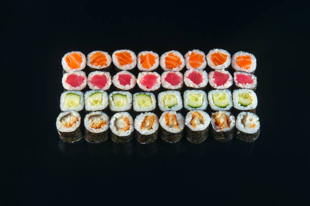 istock Big sushi rolls set served on black background 1196478762