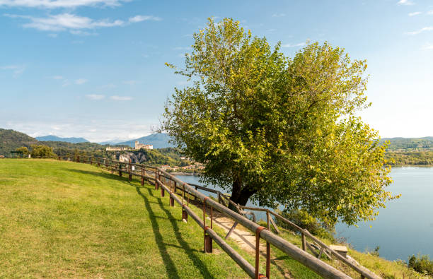 view of borromeo castle at angera from the public park of rocca borromeo of arona, italy - angera imagens e fotografias de stock