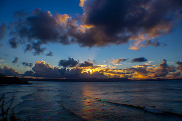 istock Sunset Surfers Surfing Scenic 1196479836