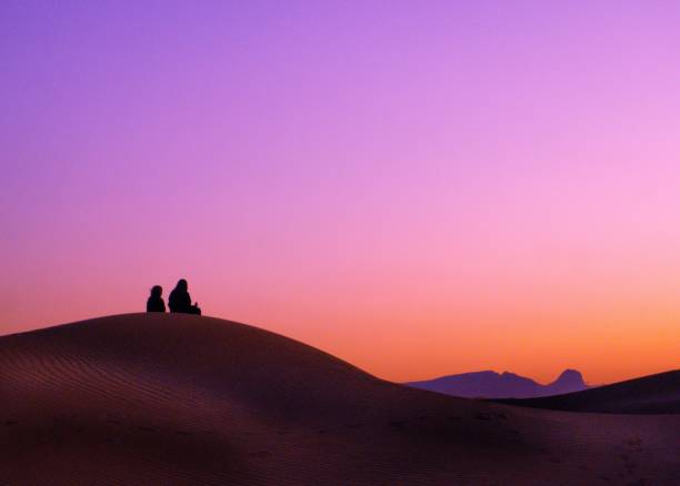 Bedouin watching the sunrise Bedouin watching the sunrise in Dubai, uae arabian desert stock pictures, royalty-free photos & images