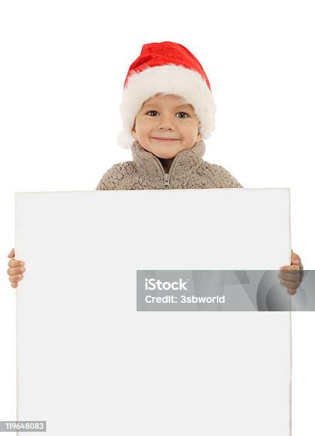Kleine Junge In Christmas Mütze Mit Einem Leeren Banner Stockfoto und mehr Bilder von Ein Junge allein