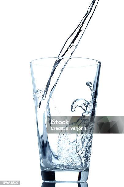 Closeup Of Water Being Poured Into A Clear Glass Stock Photo - Download Image Now - Blue, Close-up, Cold Drink