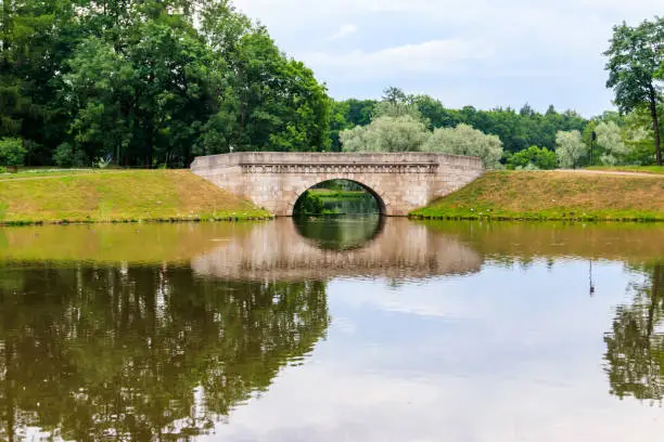 Stone arch bridge across a lake in Gatchina, Russia