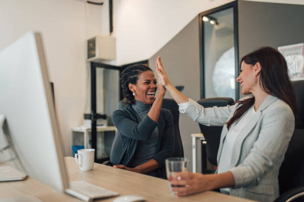 istock Happy business partners high five in modern office. 1196485631
