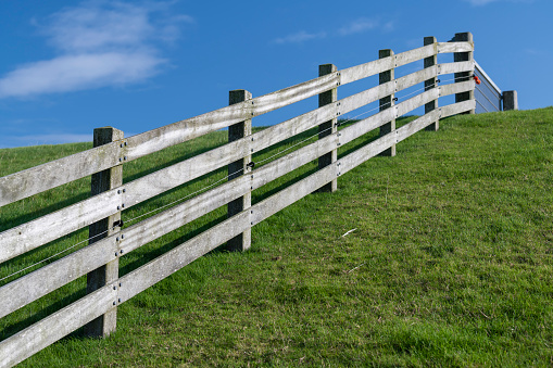 Wooden fence on the embankment of the seafront of the island of Terschelling in the northern Netherlands