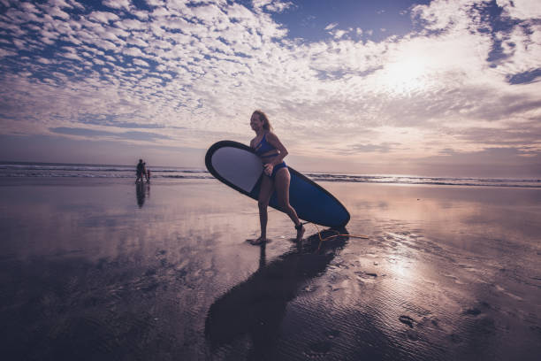 istock Surf woman. 1196491244