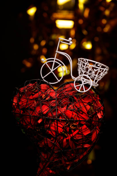 istock bicycle petal heart dark background 1196492216