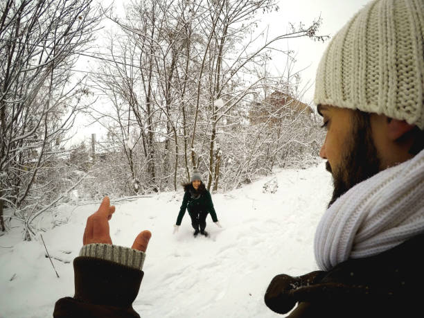 istock A young couple having a snowball fight 1196493983
