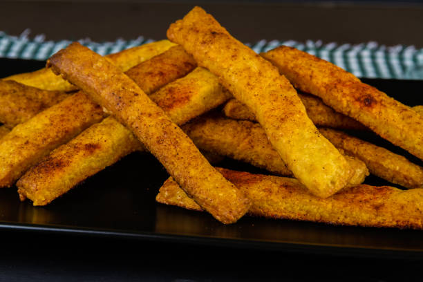 istock Home made cheese straws on dark background, side view. 1196493999