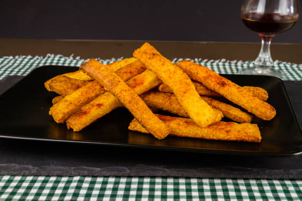 istock Home made cheese straws on plate on slate, side view. 1196494005
