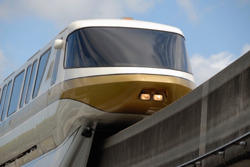 White and gold monorail train in motion