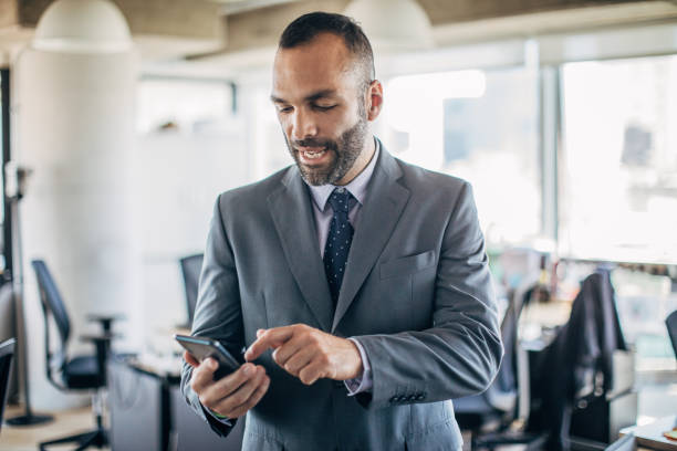 istock Businessman texting on the phone 1196502988